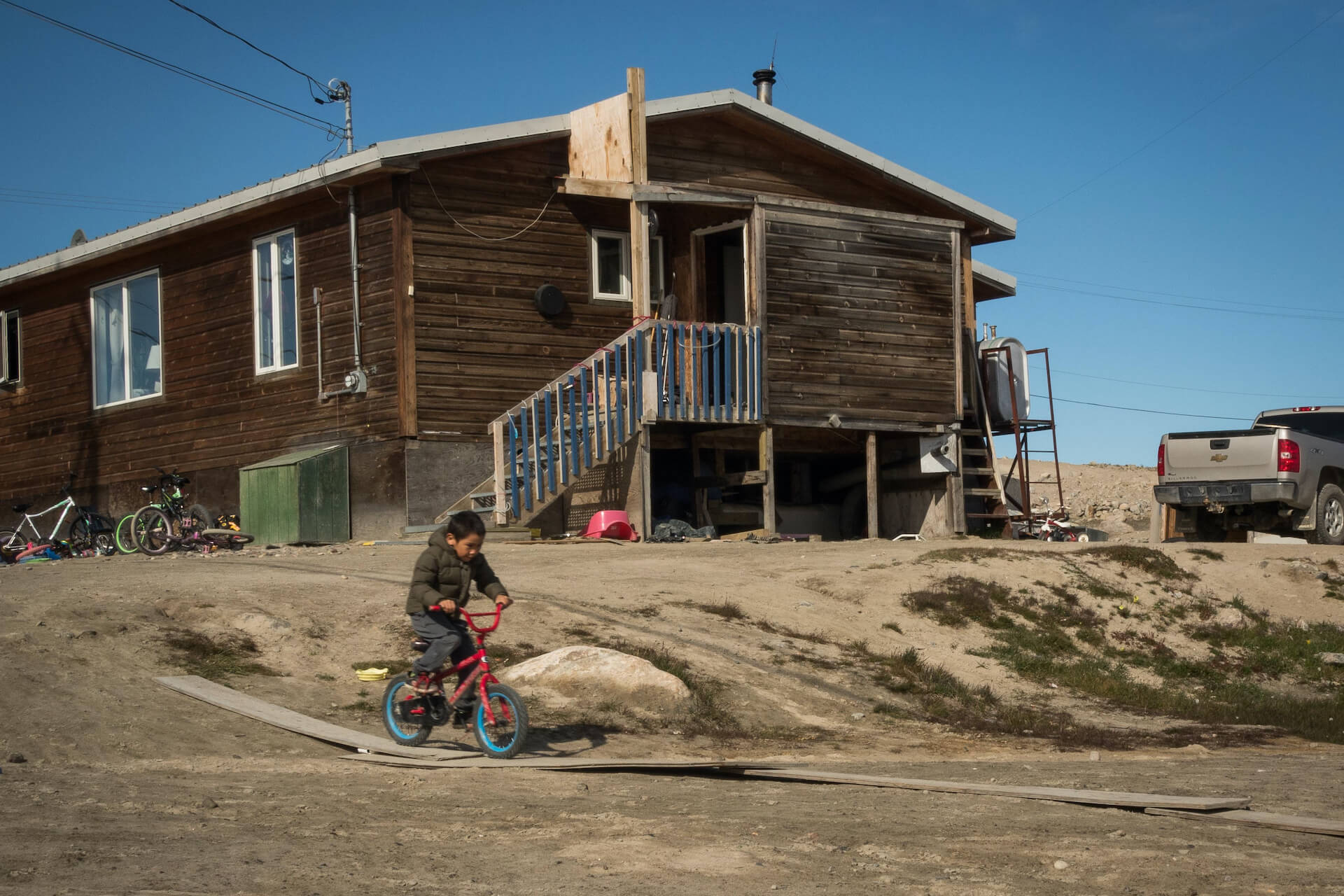 young Indigenous boy on a bicycle in remote area